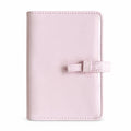 Blush pink bow A7 Pocket six-ring planner binder cover on a white background