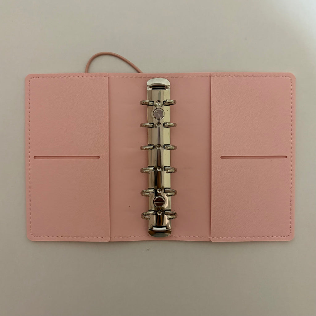 Inside view of a vegan leather A7 6-ring planner cover showing card pockets
