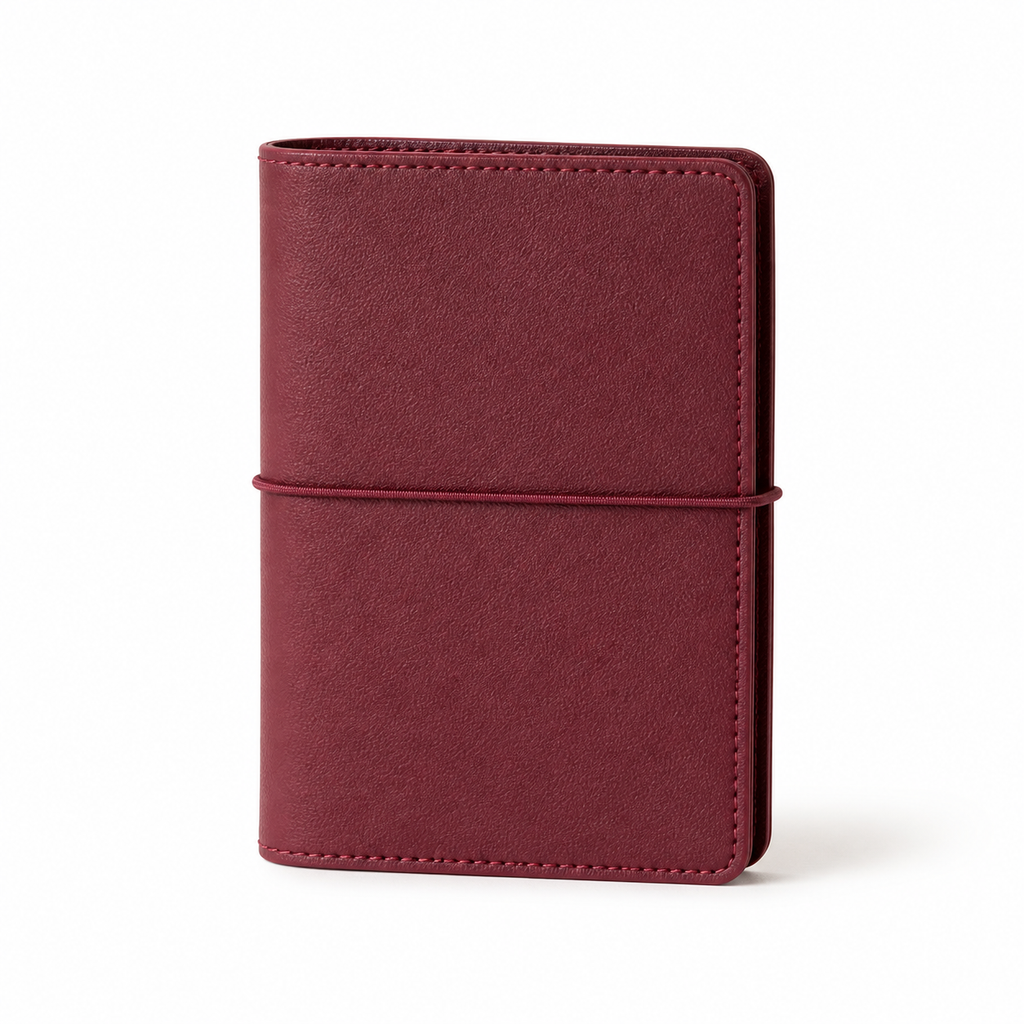 Burgundy A7 Pocket six-ring planner cover with elastic closure on a white background