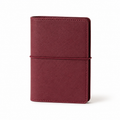 Burgundy A7 Pocket six-ring planner cover with elastic closure on a white background