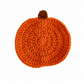 Orange crochet pumpkin coaster on a pure white background