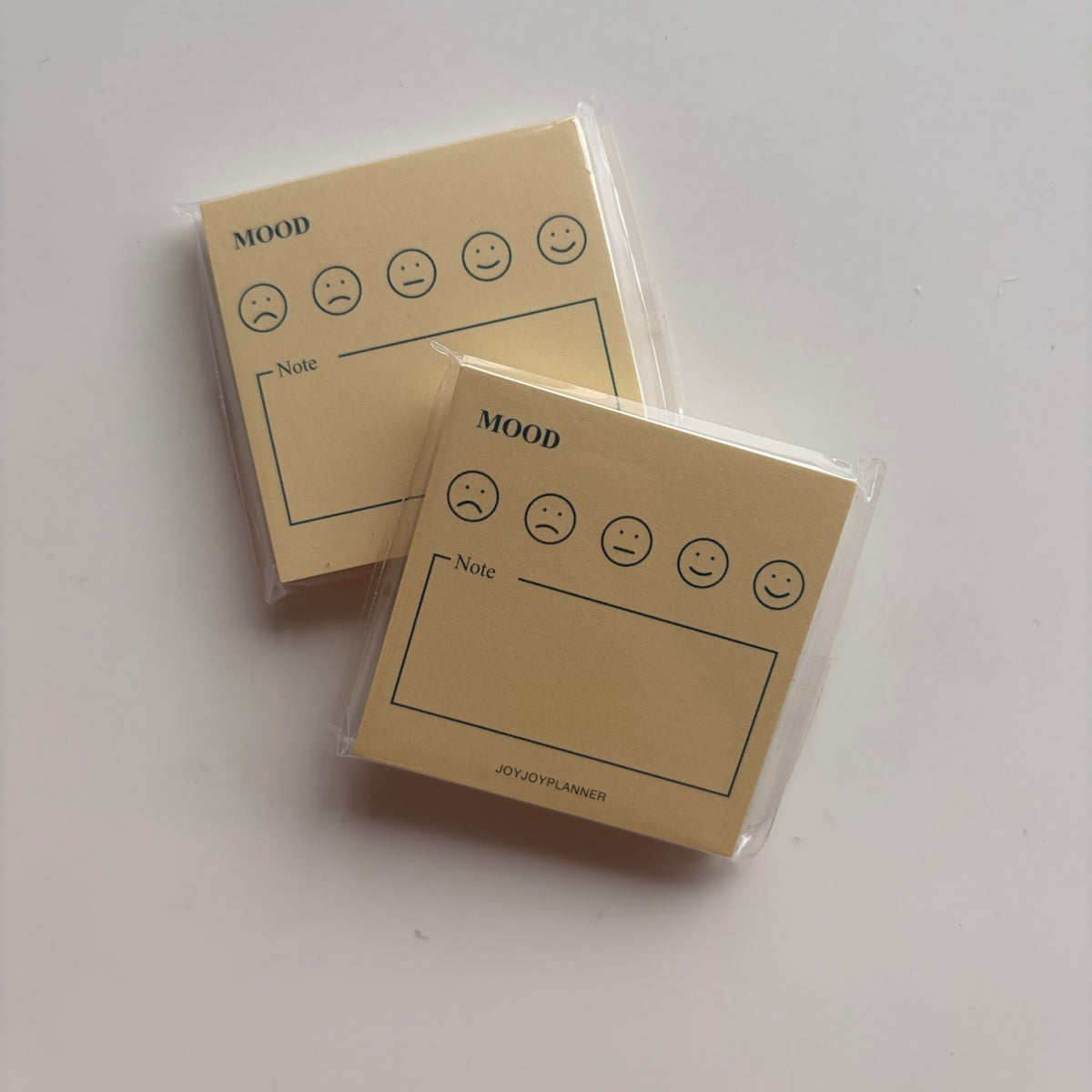 Real photo of two packaged Daily Mood Tracker mini memo pads