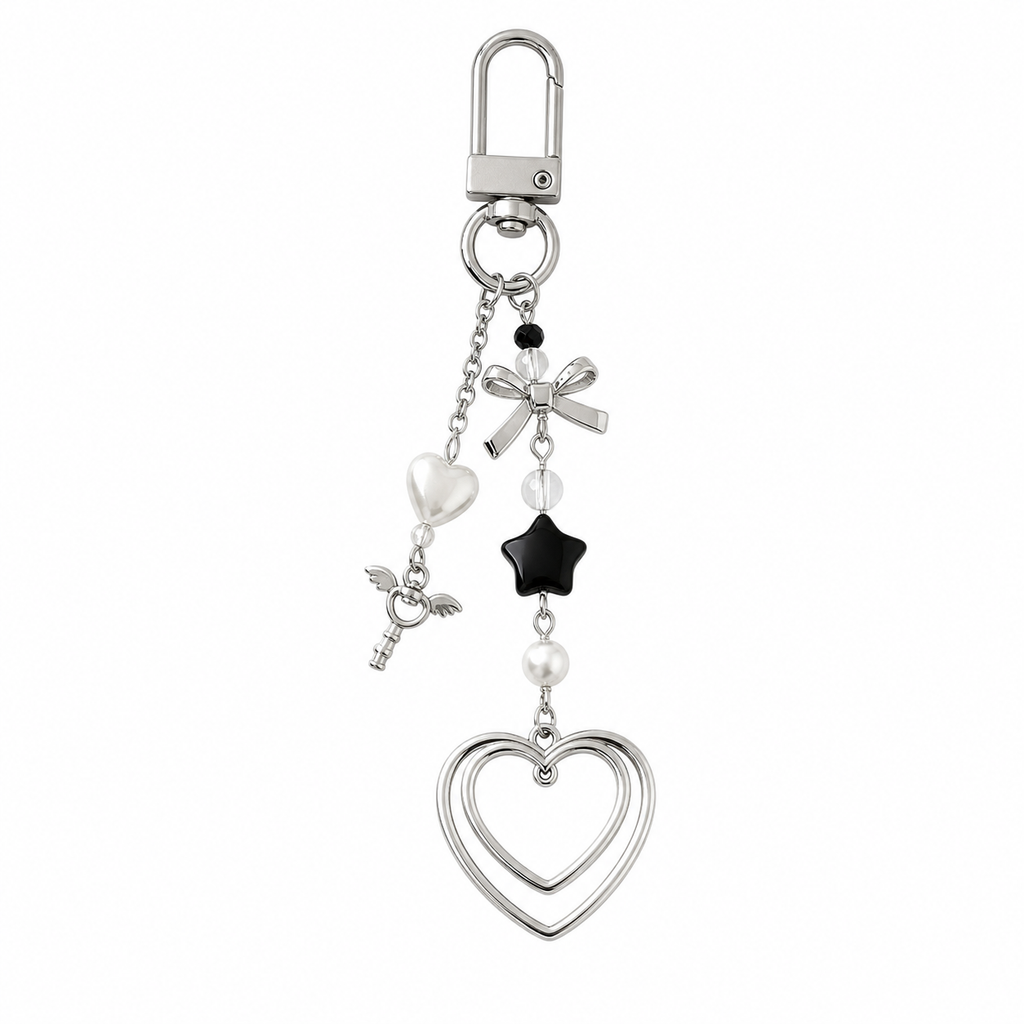 Dark double heart keychain charm with black star bead and silver bow on a white background