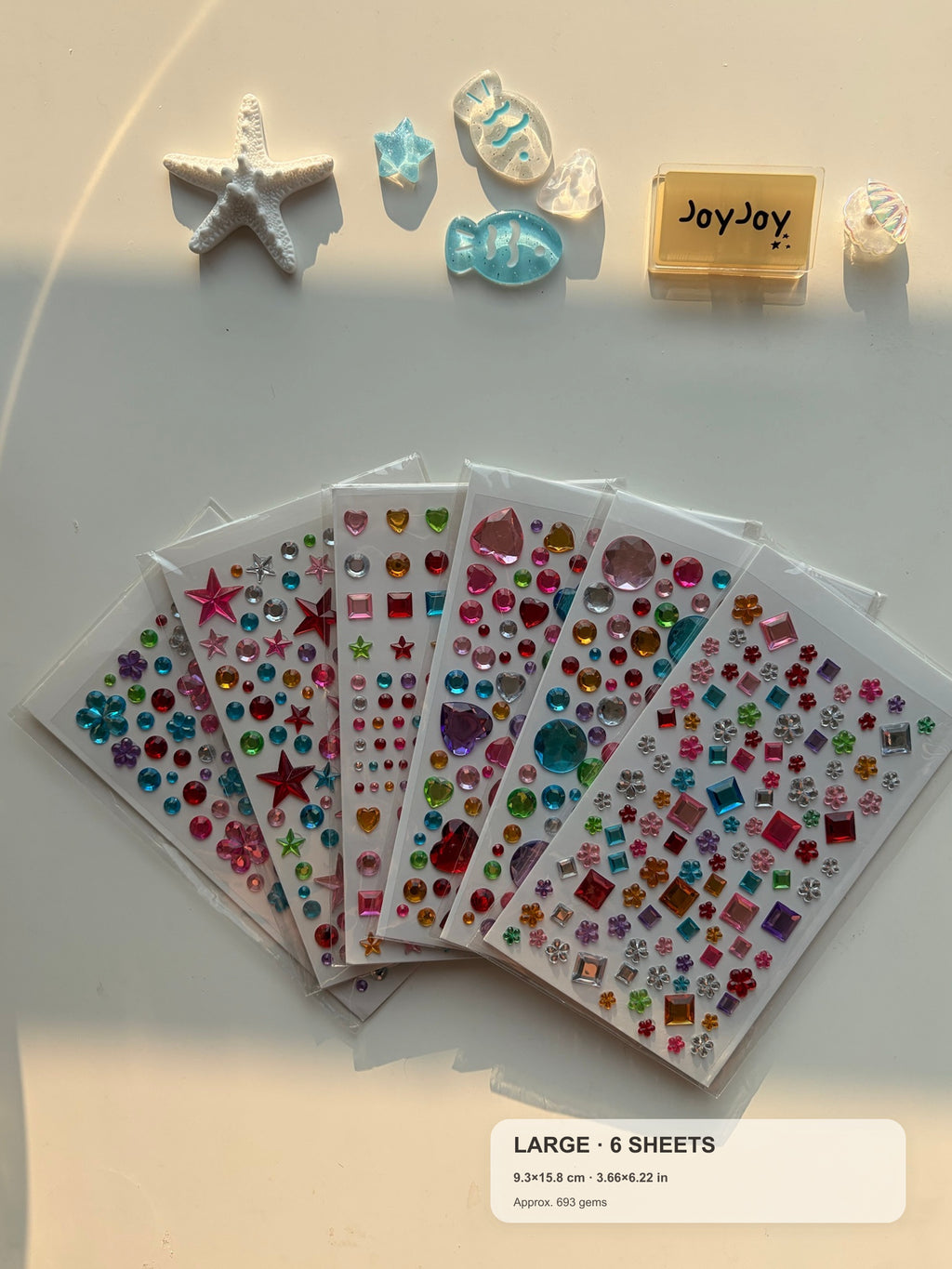 Centered-crop Large Variety gem sticker pack fanned out with compact size guide: 6 sheets and approximately 693 gems