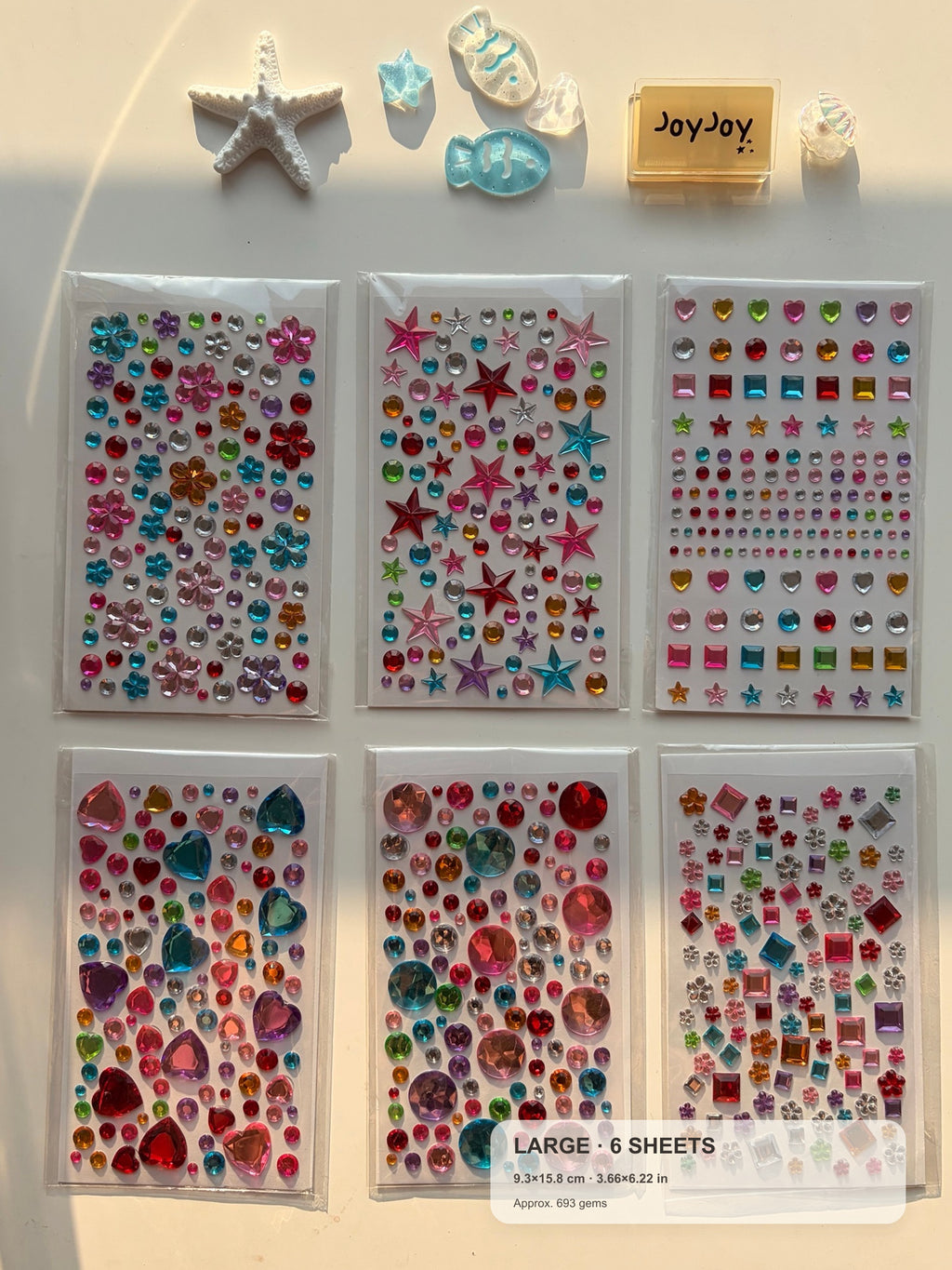 Centered-crop Large Variety gem sticker pack with compact size guide: 6 sheets at 9.3 × 15.8 cm each, approximately 693 gems