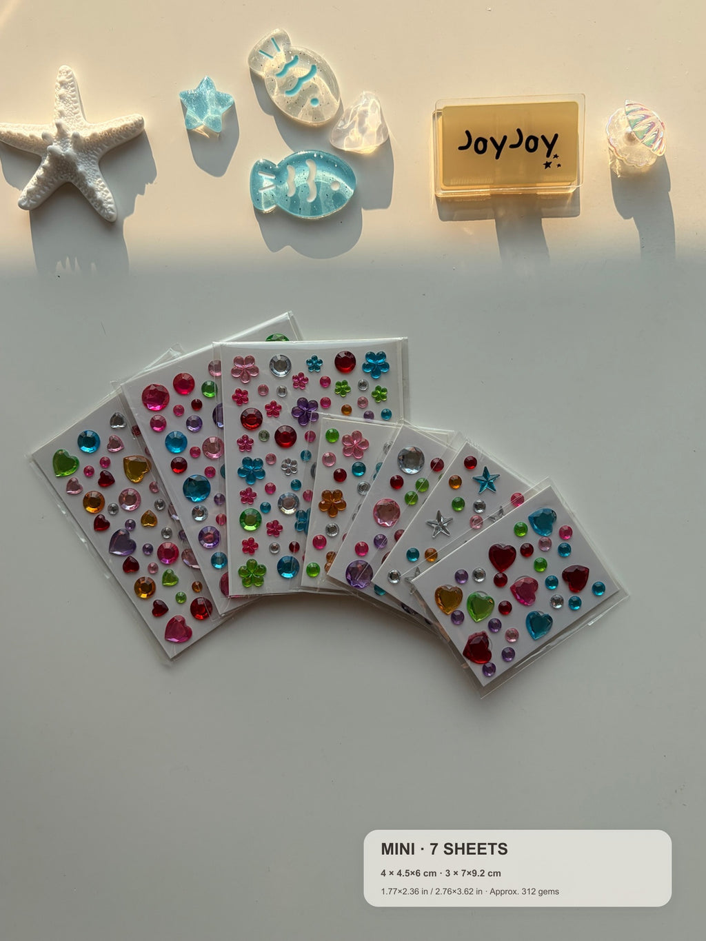 Centered-crop Mini Variety gem sticker pack fanned out with compact size guide: 7 sheets and approximately 312 gems
