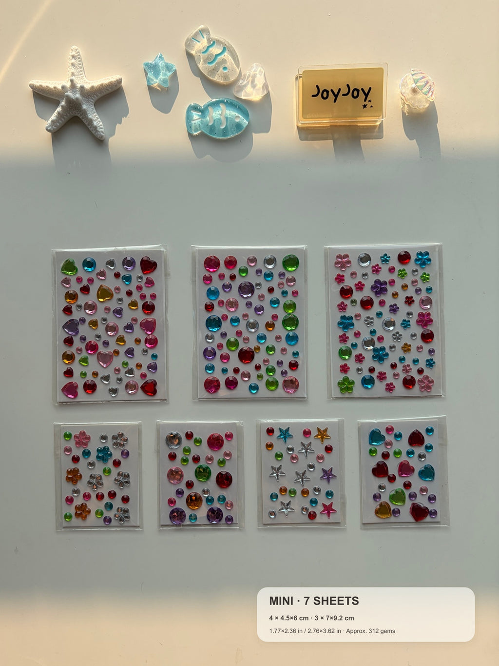 Centered-crop Mini Variety gem sticker pack with compact size guide: 7 sheets, 4 sheets at 4.5 × 6 cm and 3 sheets at 7 × 9.2 cm, approximately 312 gems