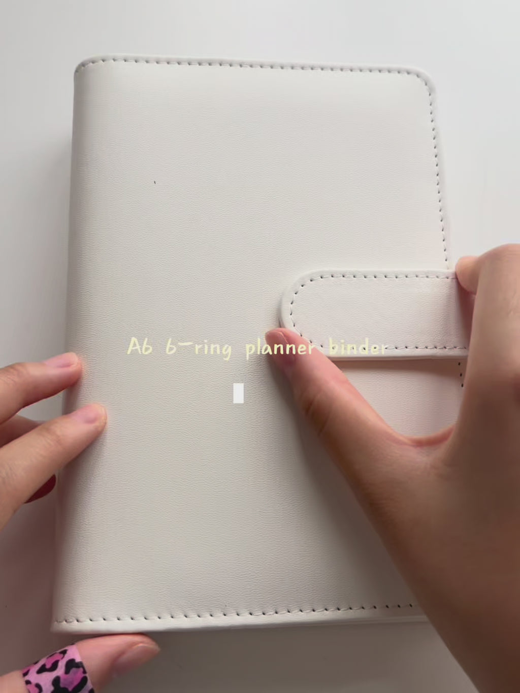 White A6 Macaron planner binder feature demonstration; inserts and accessories shown are not included