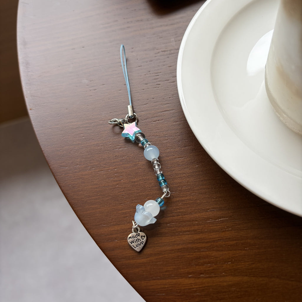 Sea Salt Moon blue beaded phone and planner charm styled in a desk setup
