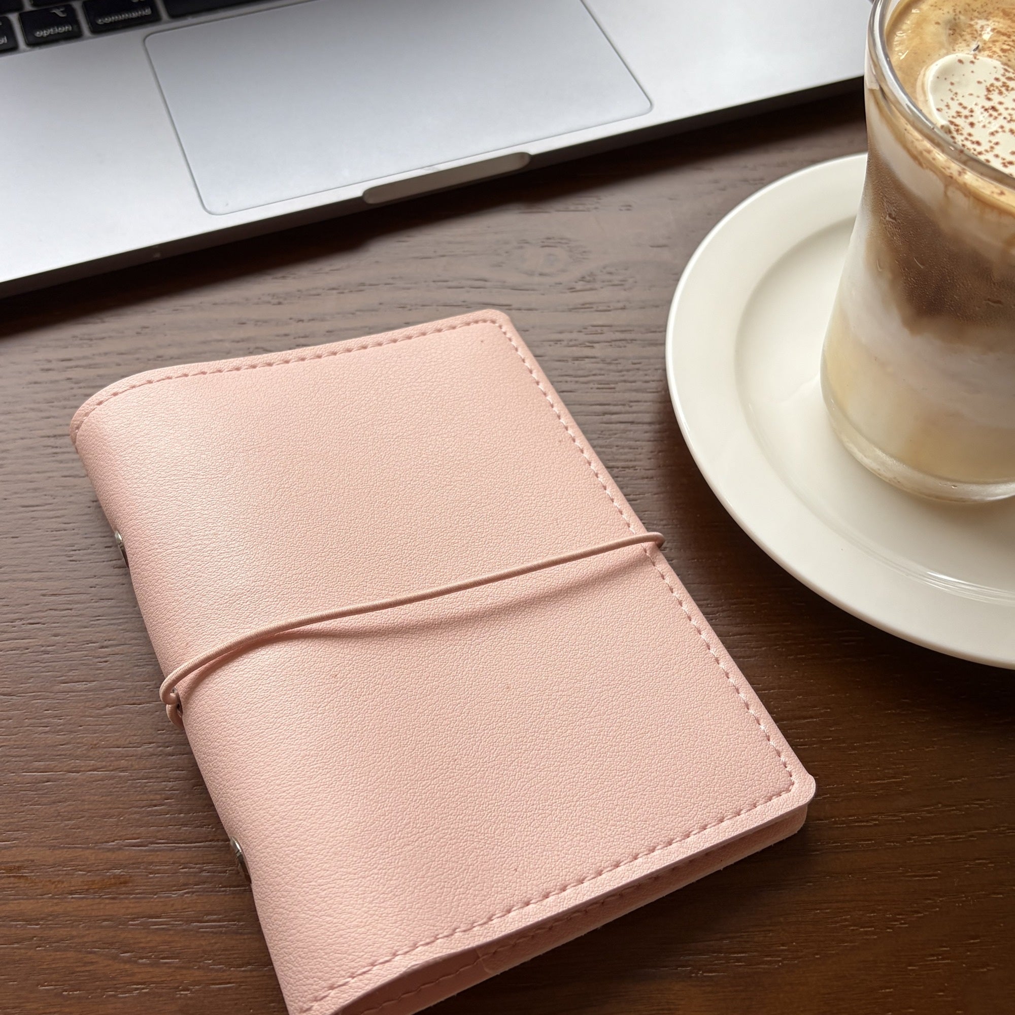 Soft pink A7 pocket planner cover styled on a cafe table