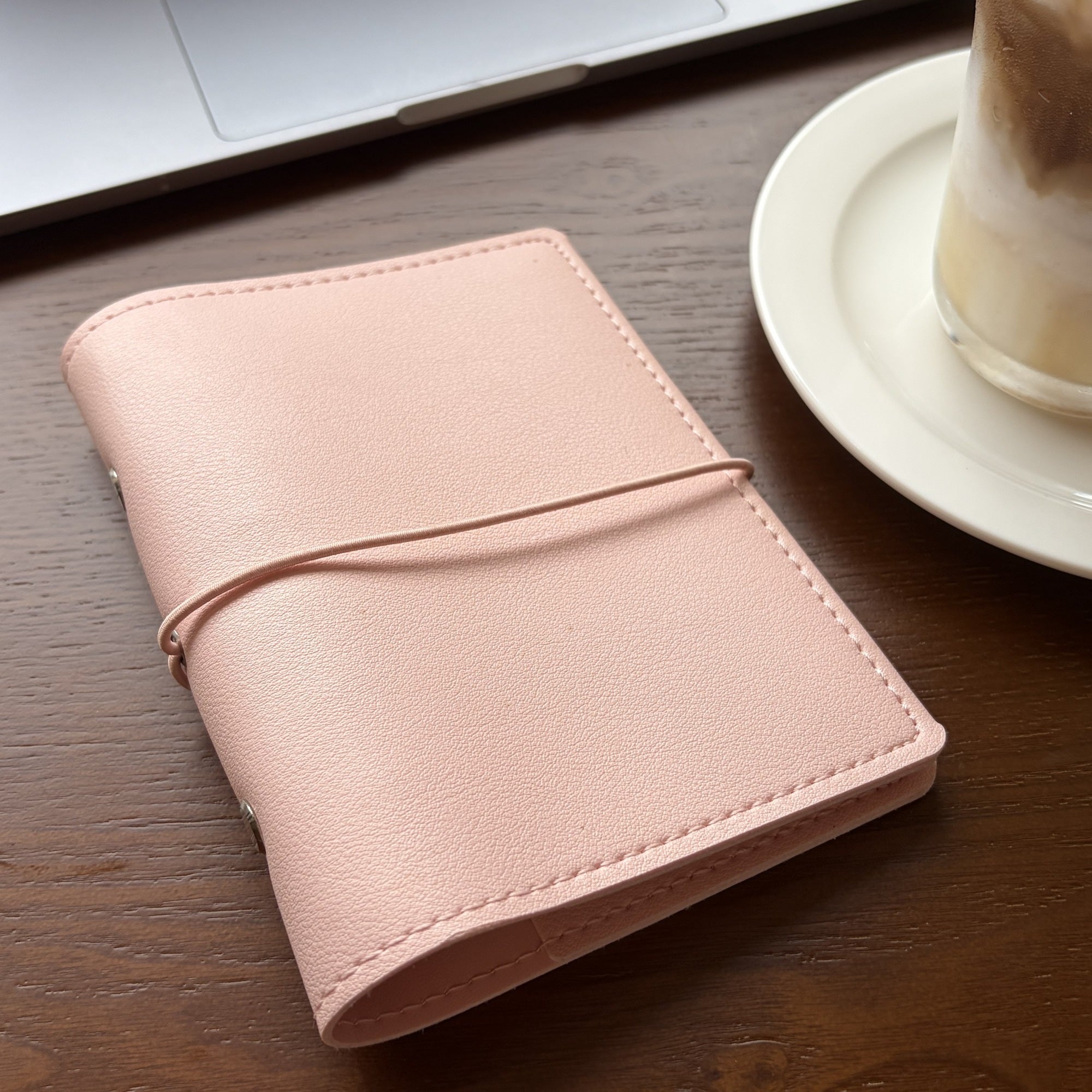 Soft pink six-ring pocket planner cover detail with elastic closure