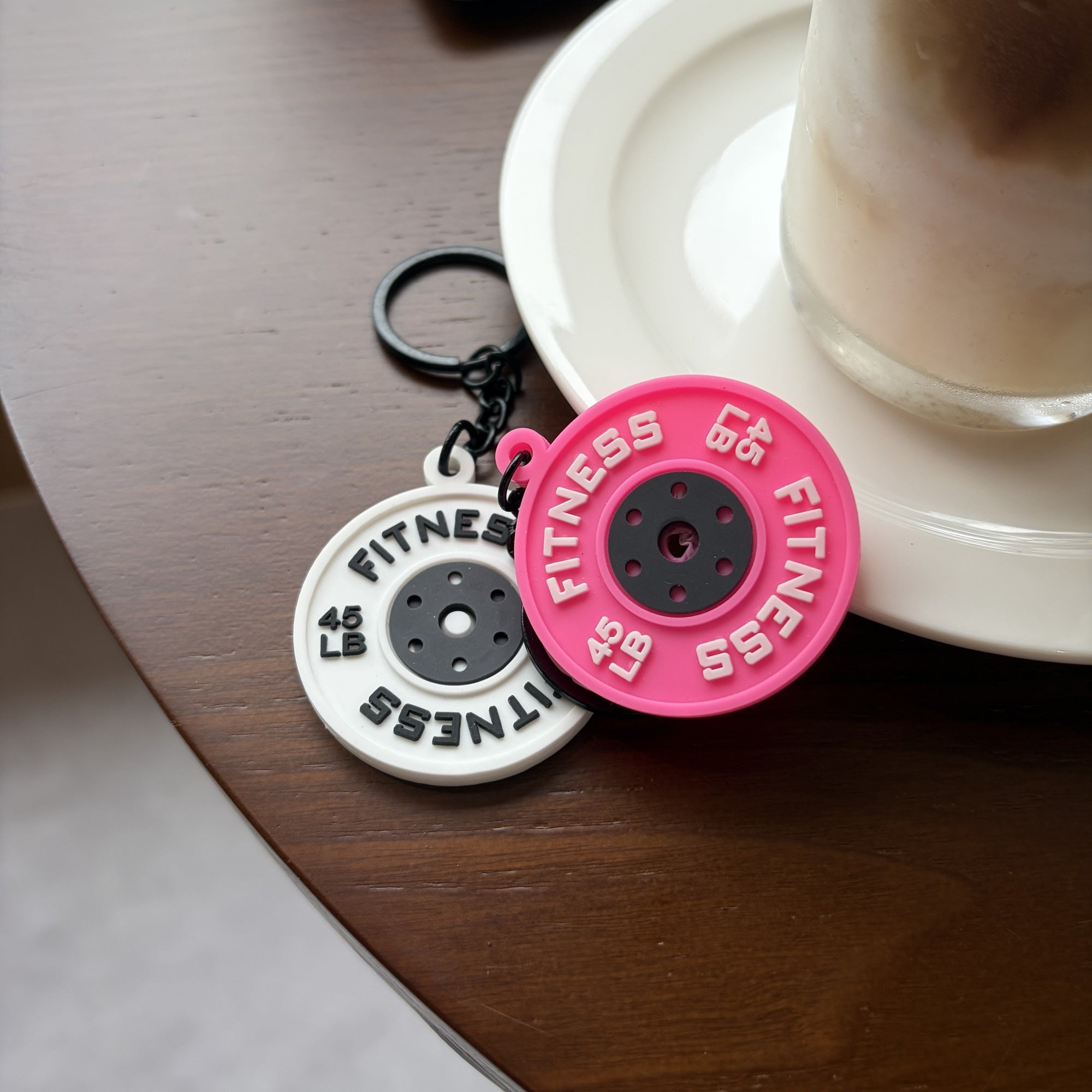 White and purple mini weight plate planner charms styled on a cafe table