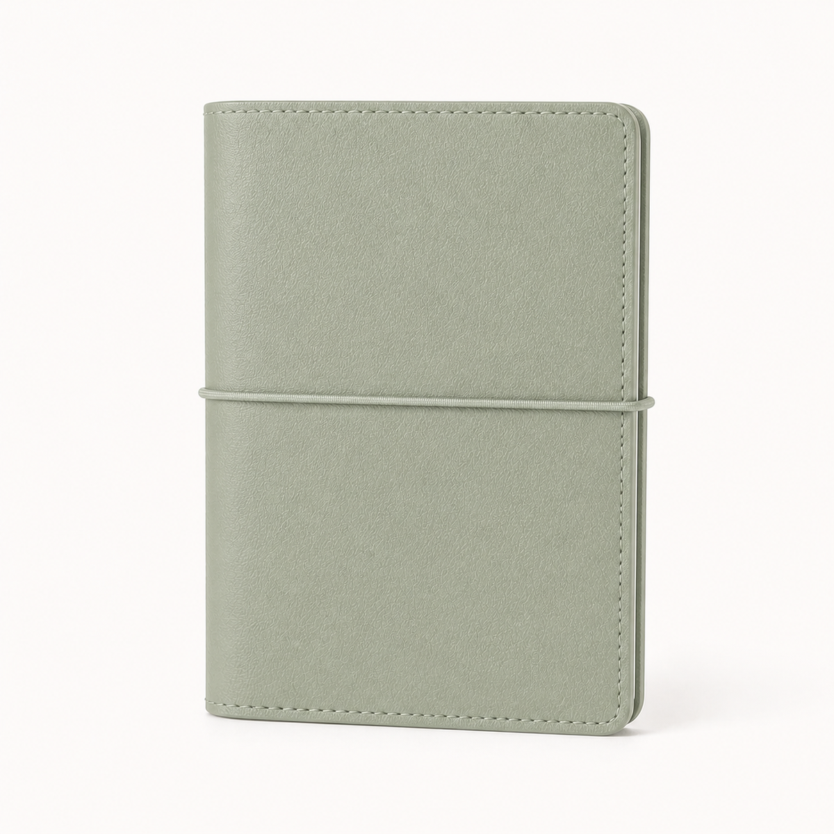 Soft Green A7 Pocket six-ring planner cover with elastic closure on a white background