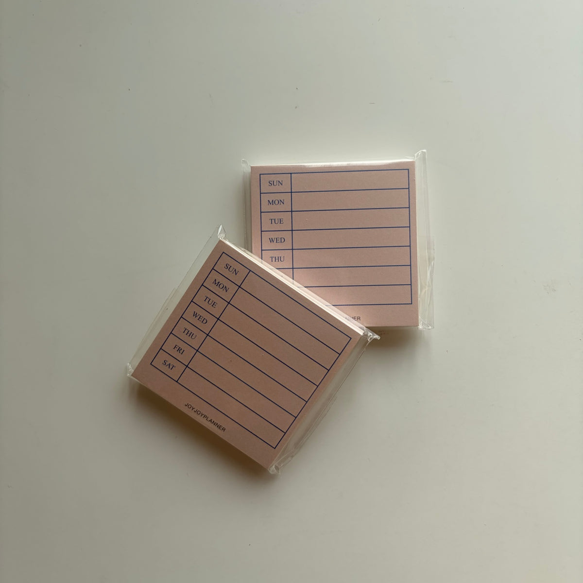 Real photo of two packaged Sunday-start Weekly Planner mini memo pads