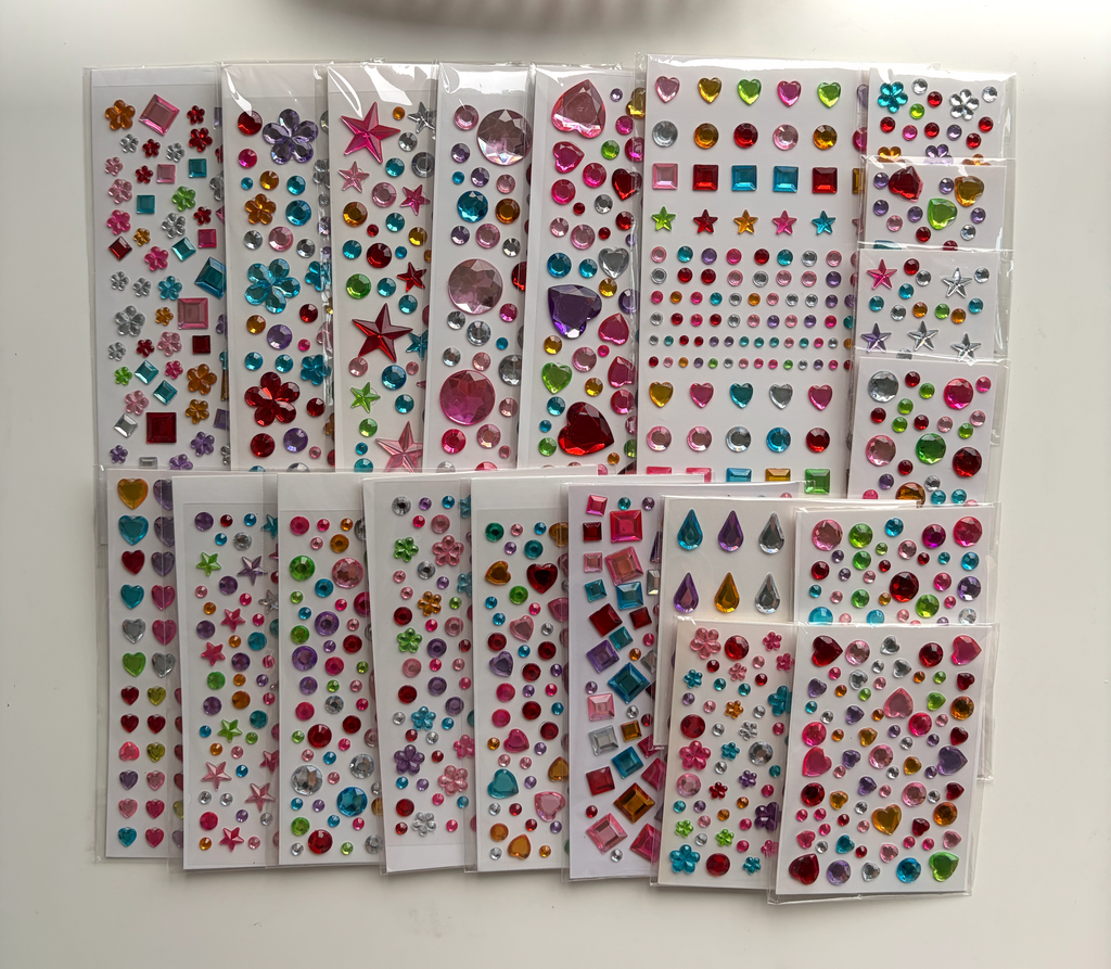 Twenty colorful Whimsy Gems sticker sheets arranged together with the complete assortment visible