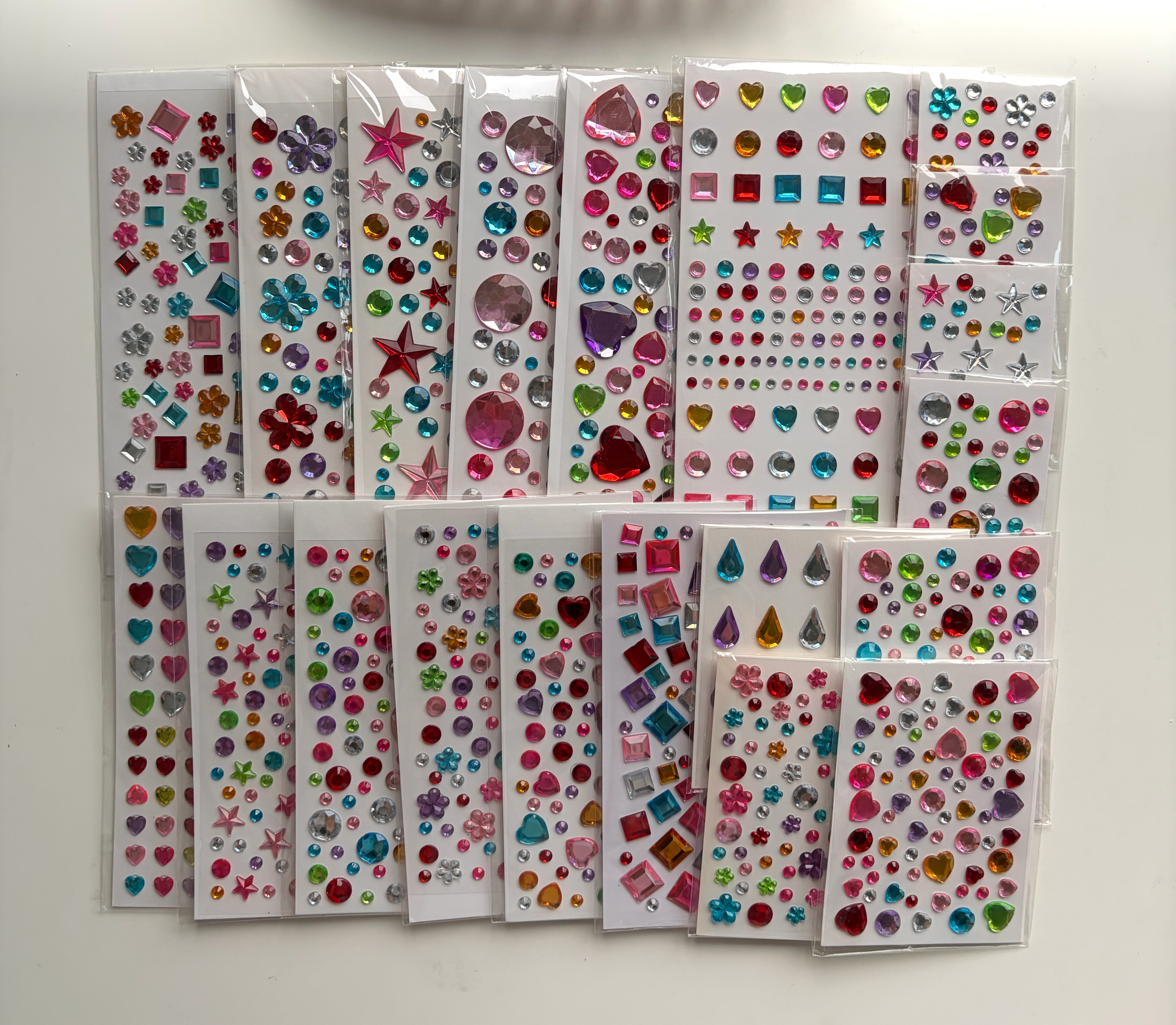 Twenty colorful Whimsy Gems sticker sheets arranged together with the complete assortment visible