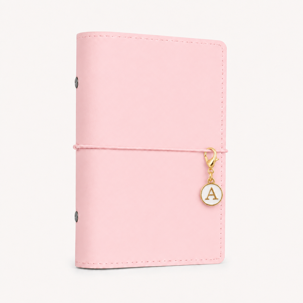White and gold initial planner charm clipped to a baby pink Soft Series A6 ring planner